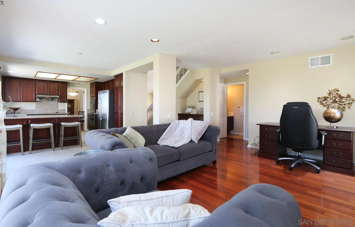 13375 Roxton Circle San Diego, CA 92130 - Photo 7 of 29 a living room with furniture kitchen view and a wooden floor