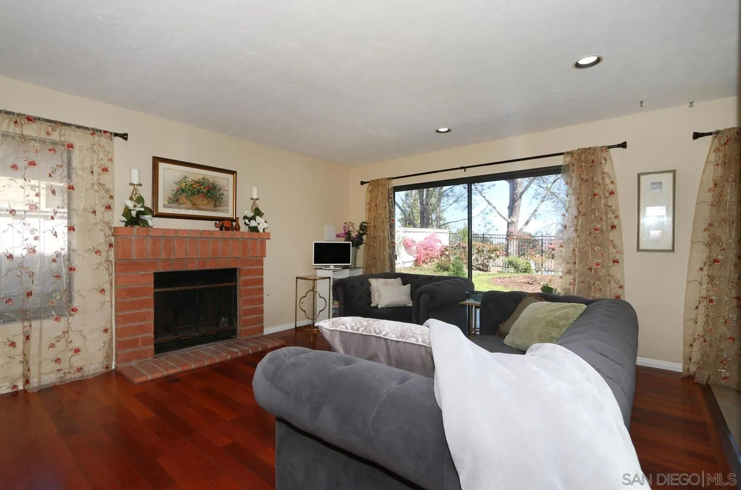 13375 Roxton Circle San Diego, CA 92130 - Photo 10 of 29 a living room with furniture large window and fireplace