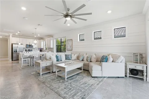 a living room with furniture and a view of kitchen