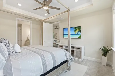 a bedroom with a bed and a potted plant