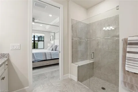 a en suite bathroom with a sink a mirror and shower