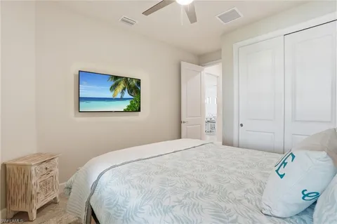 a bedroom with a bed and a painting on the wall