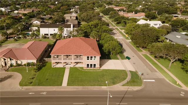 an aerial view of residential houses with outdoor space