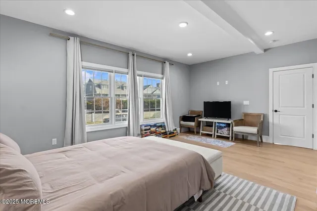 a bedroom with a large bed and a large window