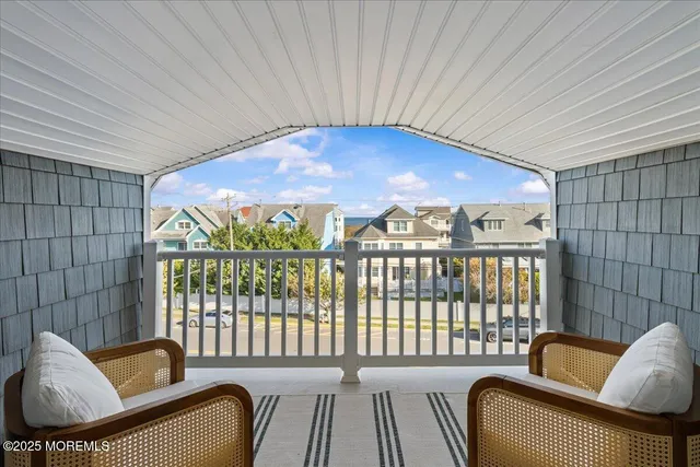 a view of a livingroom with furniture and a flat screen tv