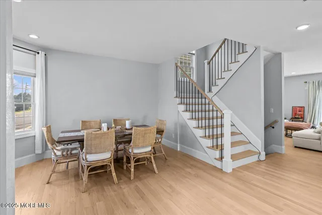 a view of a dining room with furniture wooden floor and white walls