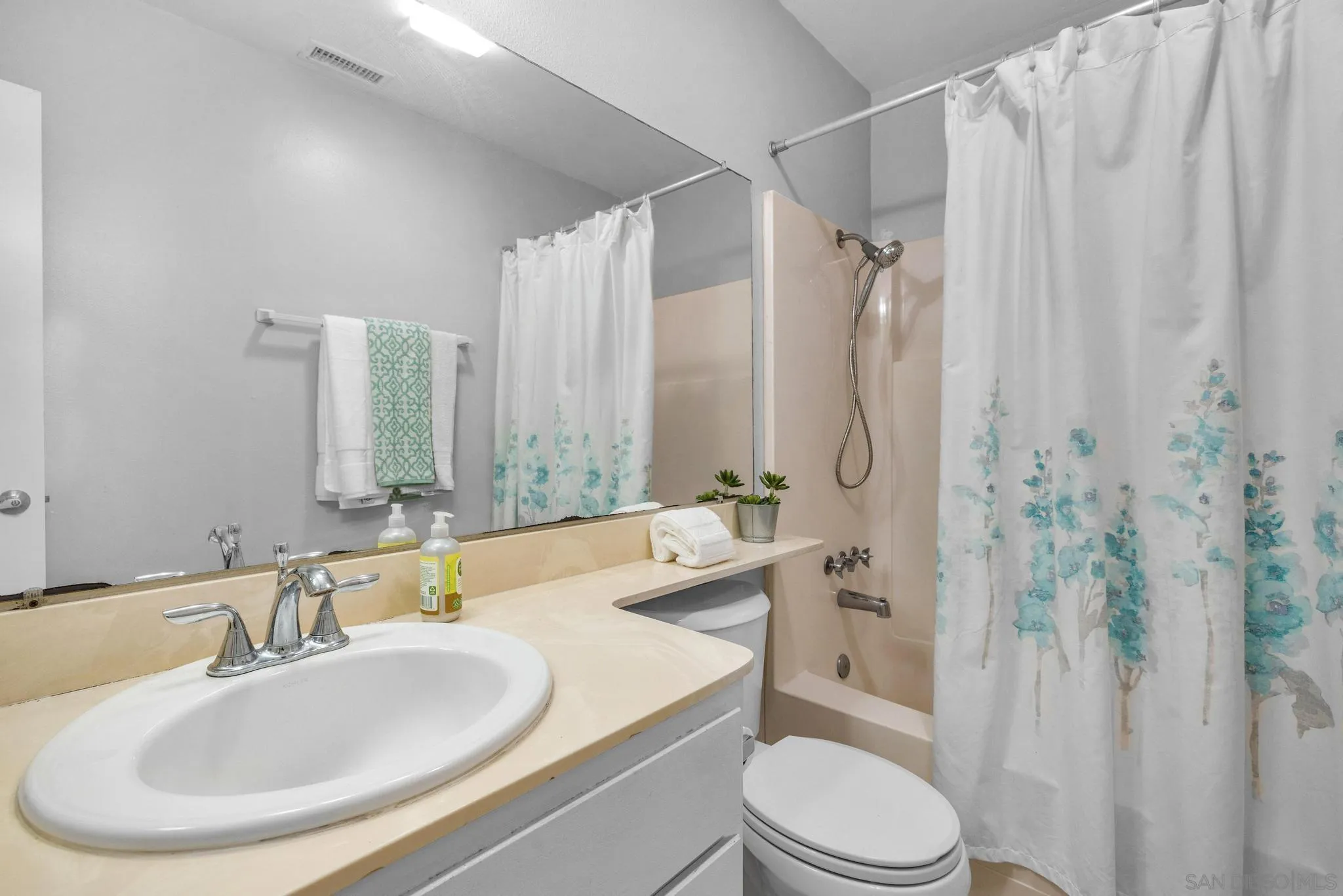 1841 Gatepost Road Encinitas, CA 92024 - Photo 16 of 30 a bathroom with a sink toilet a mirror and shower