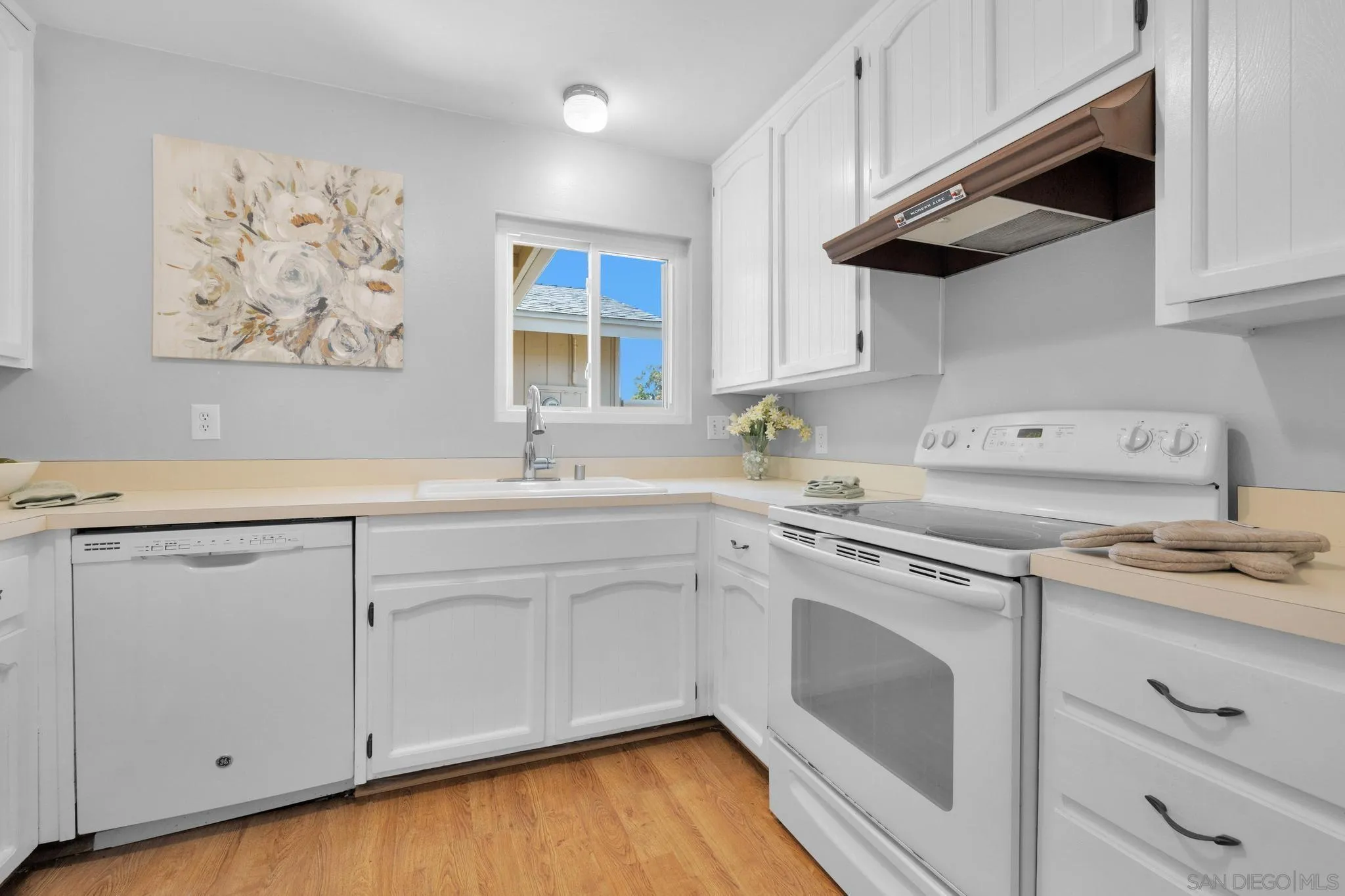 1841 Gatepost Road Encinitas, CA 92024 - Photo 9 of 30 a kitchen with stainless steel appliances white cabinets and a sink