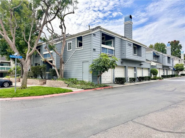 a view of a hallway with wooden floor and a kitchen