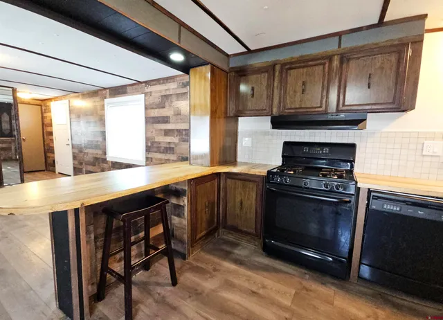 a kitchen with stainless steel appliances a stove a sink and a microwave
