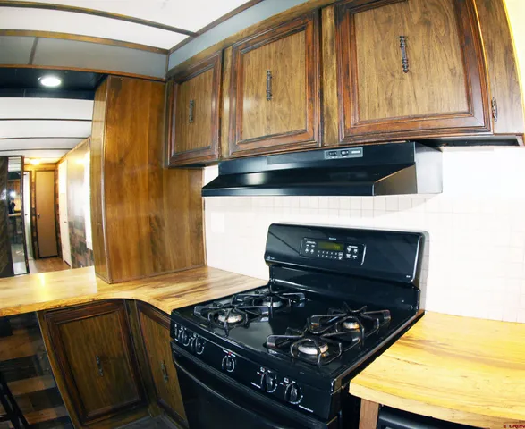 a kitchen with stainless steel appliances granite countertop a stove and a microwave