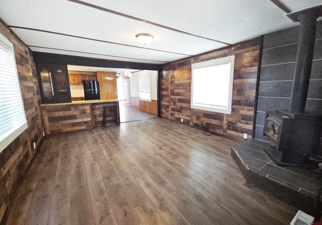 a room with wooden floor and furniture on the wall