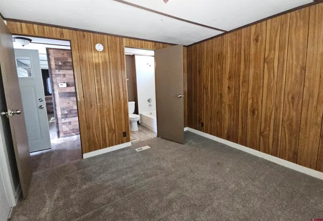 a view of a big room with windows and furniture