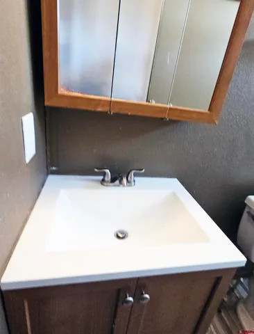 a view of a house with backyard and a tree