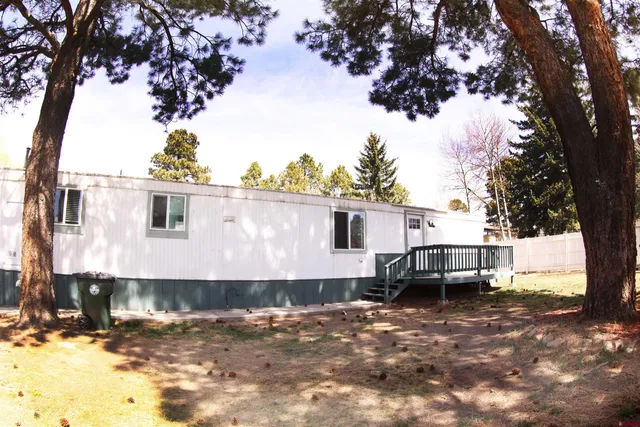 a view of a house with a yard covered with snow in the background