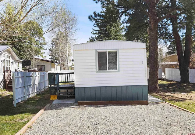 a view of backyard with a barn and large tree