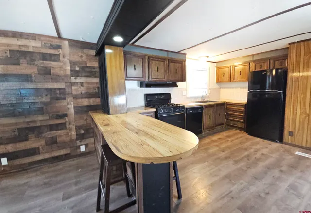 a kitchen with a table chairs refrigerator and cabinets