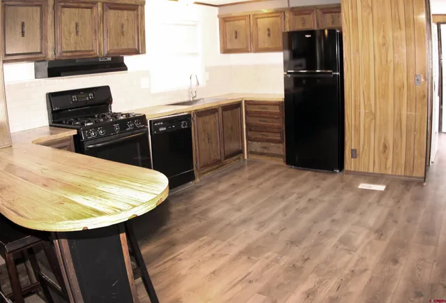 a kitchen with refrigerator and cabinets
