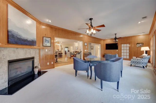 a living room with furniture and a large window with outer view