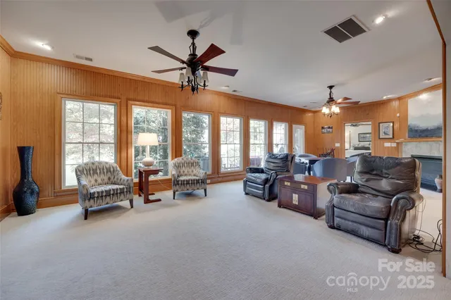 a living room with furniture and kitchen view