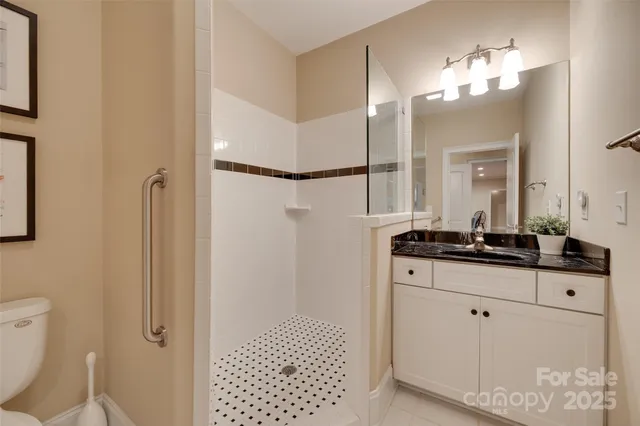 a bathroom with a sink vanity mirror and toilet