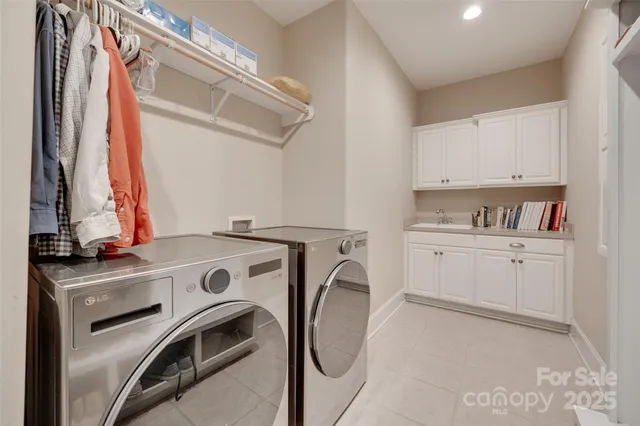 a spacious bedroom with two beds and a chandelier