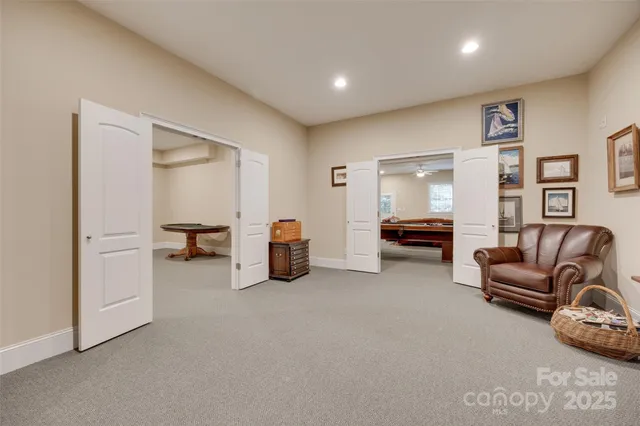 a room with pool table and windows