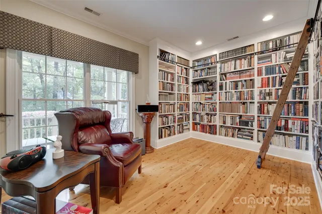a view of living room filled with furniture and book shelf