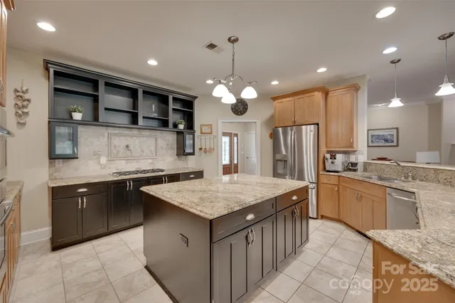 a kitchen with stainless steel appliances granite countertop a sink and cabinets