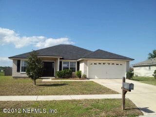 6857 Crystal River Road Jacksonville, FL 32219 - Photo 1 of 8 a front view of a house with garden