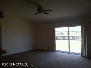 6857 Crystal River Road Jacksonville, FL 32219 - Photo 5 of 8 an empty room with a window