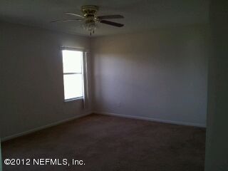 6857 Crystal River Road Jacksonville, FL 32219 - Photo 6 of 8 an empty room with a window