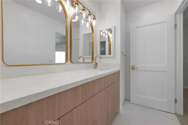 a bathroom with a double vanity sink and a mirror