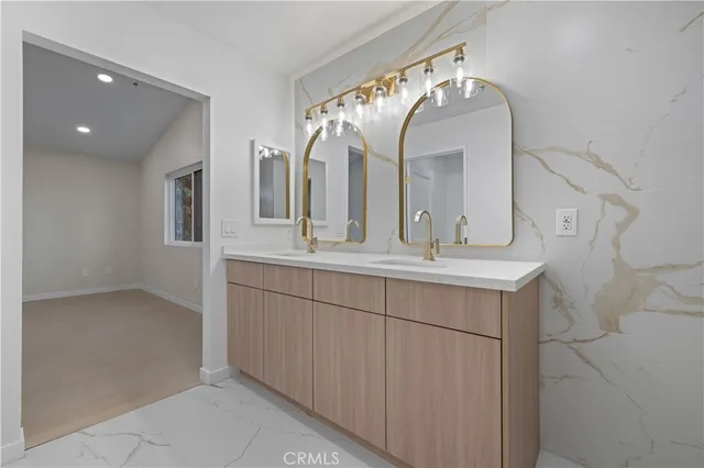 a bathroom with a double vanity sink and a mirror