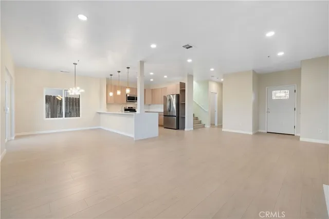 a view of a kitchen with a refrigerator and a kitchen