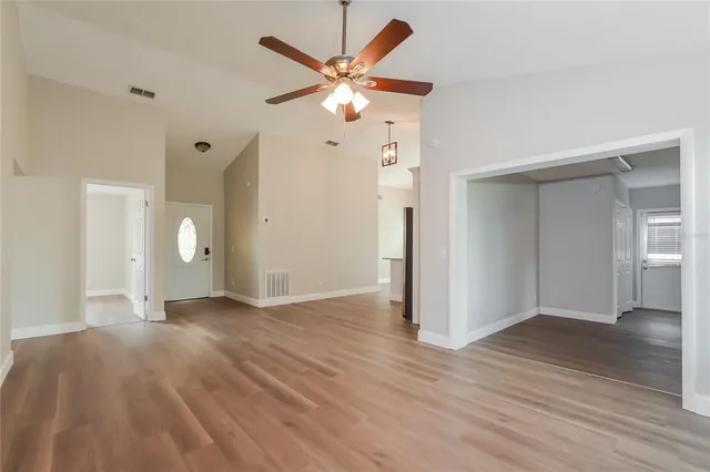 a view of an empty room with wooden floor