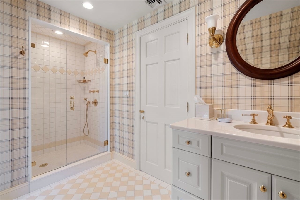 71 Sears Road Brookline, MA 02445 - Photo 12 of 18 a bathroom with a sink and a mirror