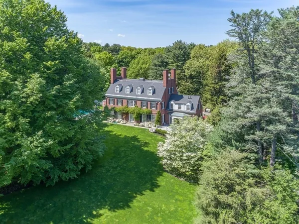 a aerial view of a house with pool yard and outdoor seating