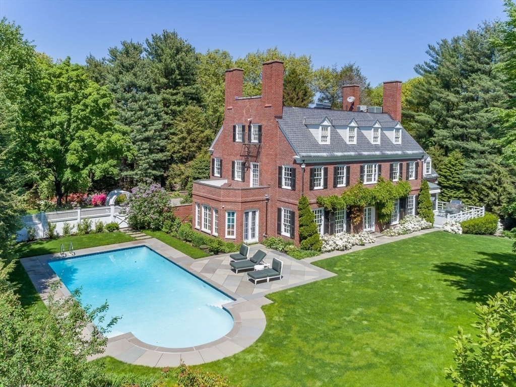71 Sears Road Brookline, MA 02445 - Photo 17 of 18 a view of a house with swimming pool and a yard