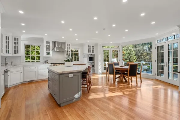 a kitchen with stainless steel appliances granite countertop a stove and a wooden floors