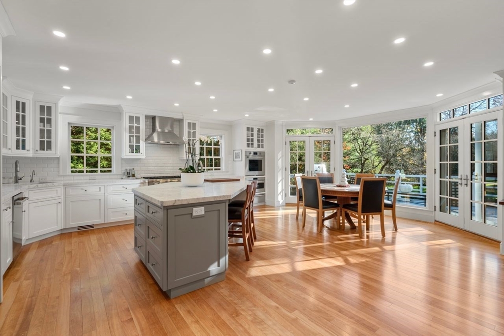 71 Sears Road Brookline, MA 02445 - Photo 3 of 18 a kitchen with stainless steel appliances granite countertop a stove and a wooden floors
