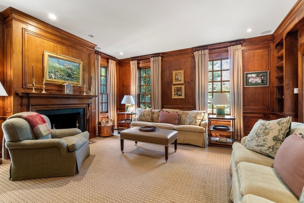 71 Sears Road Brookline, MA 02445 - Photo 5 of 18 a living room with furniture a large window and a fireplace