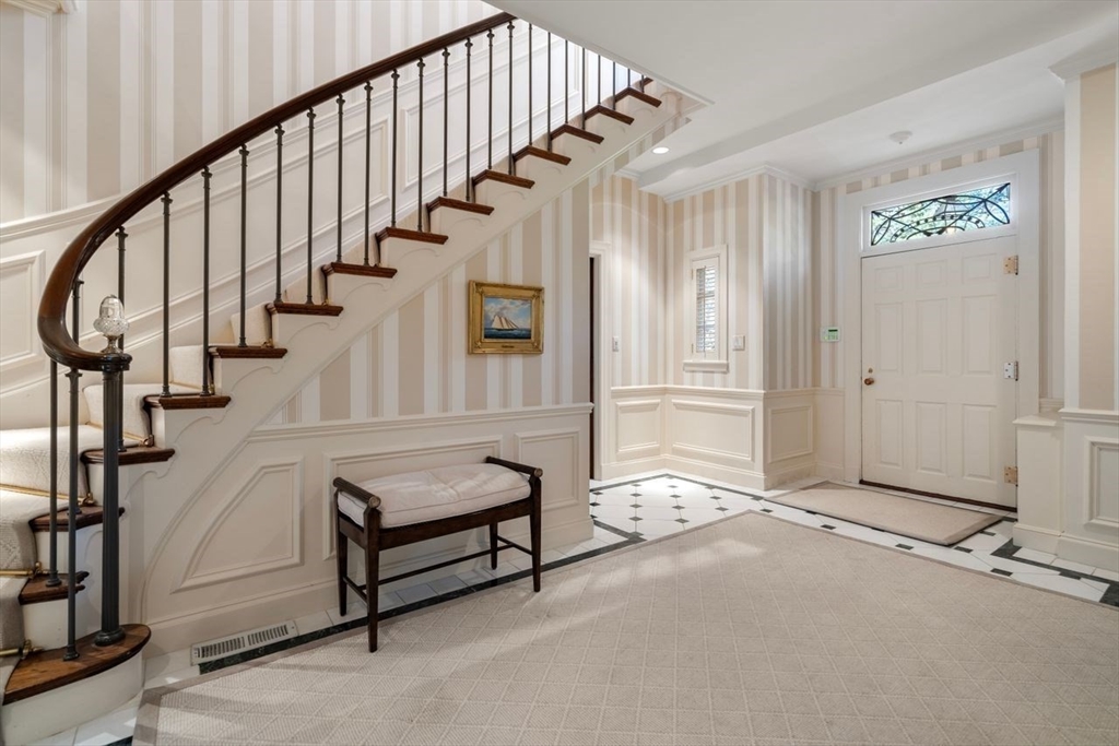 71 Sears Road Brookline, MA 02445 - Photo 8 of 18 a view of an entryway with wooden floor and stairs