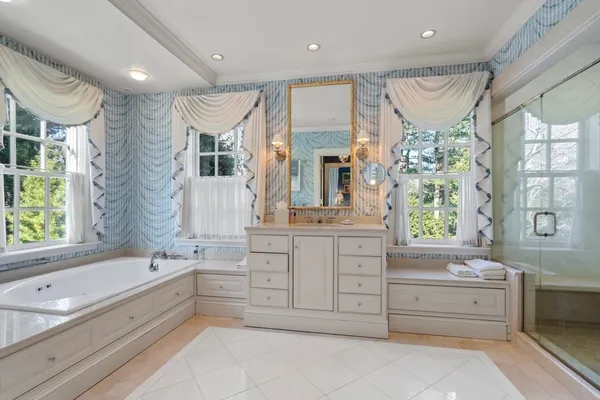 a bathroom with a granite countertop tub sink shower double vanity