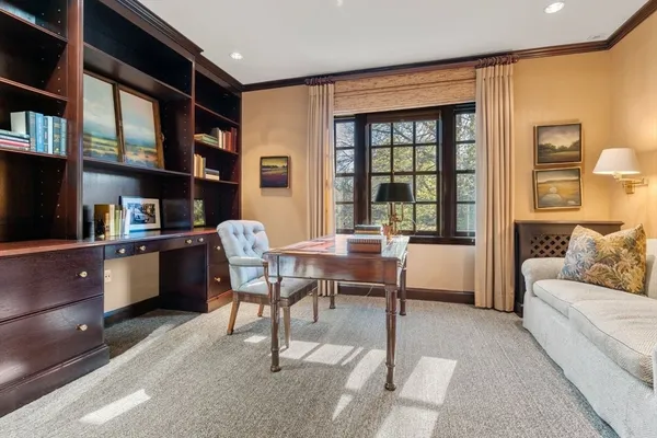 a living room with furniture a piano and a bookshelf