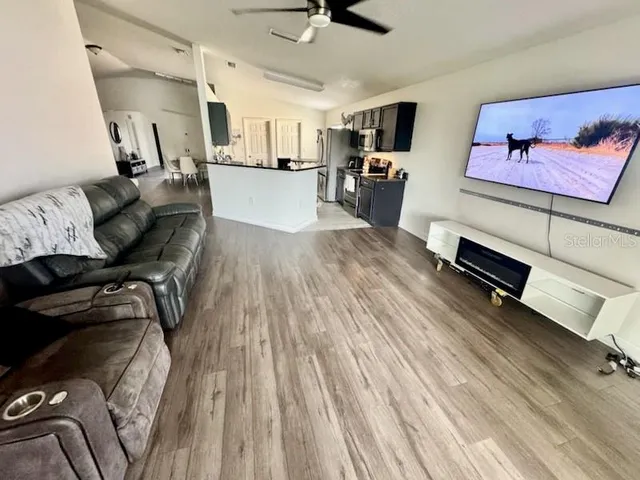 a living room with furniture and a wooden floor