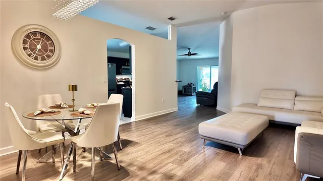 a view of a dining room with furniture and wooden floor
