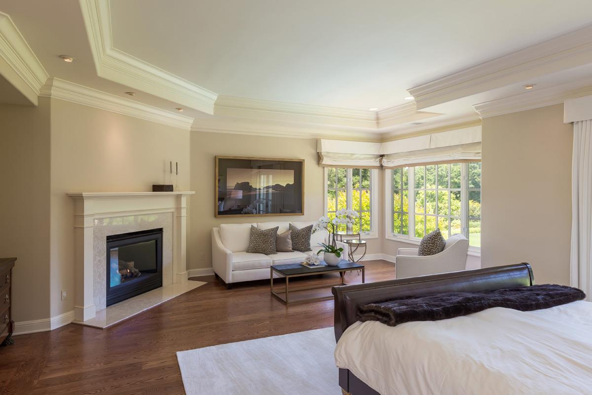 87 Patricia Drive Atherton, CA 94027 - Photo 26 of 41 a bedroom with a large bed and a fireplace