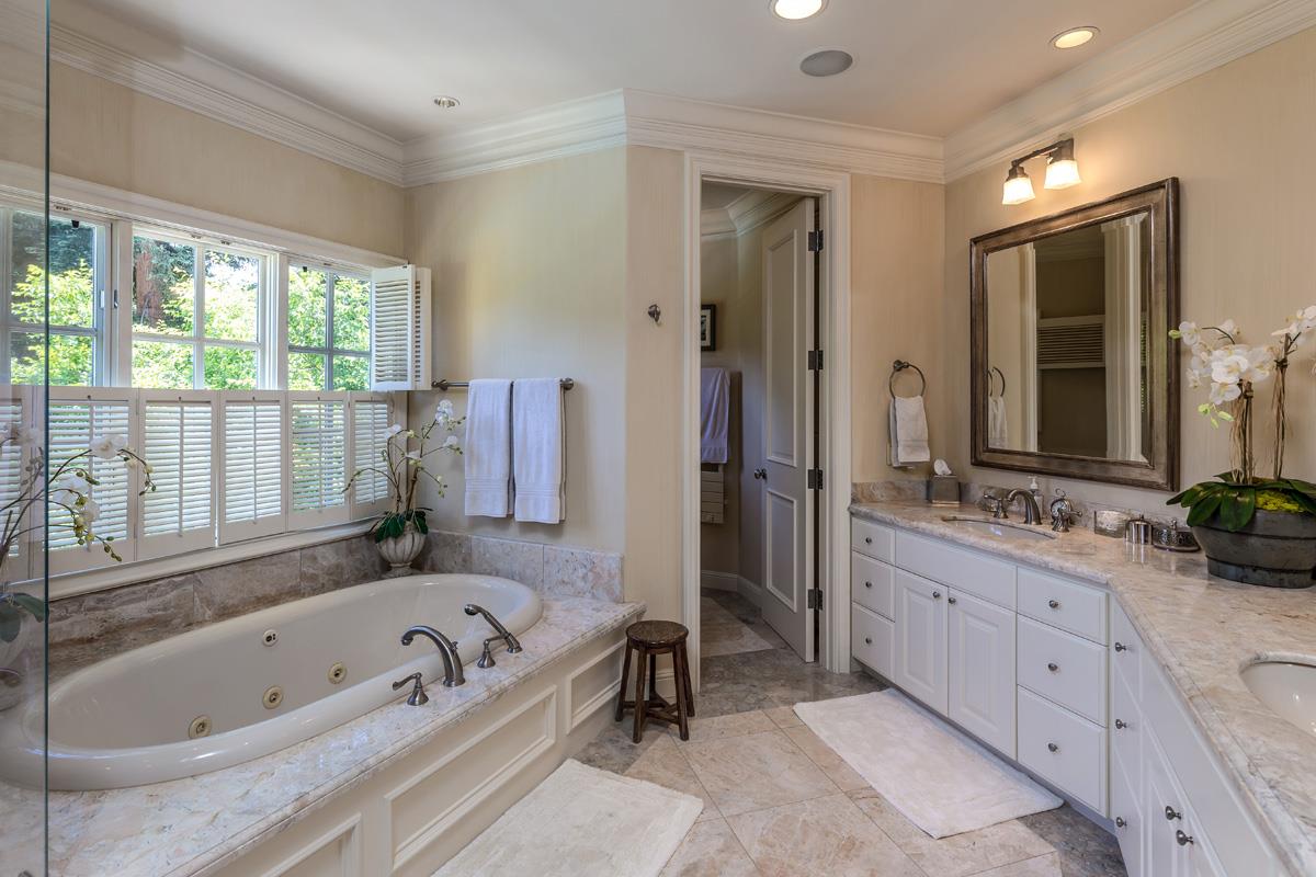 87 Patricia Drive Atherton, CA 94027 - Photo 29 of 41 a bathroom with a tub a sink and a large mirror