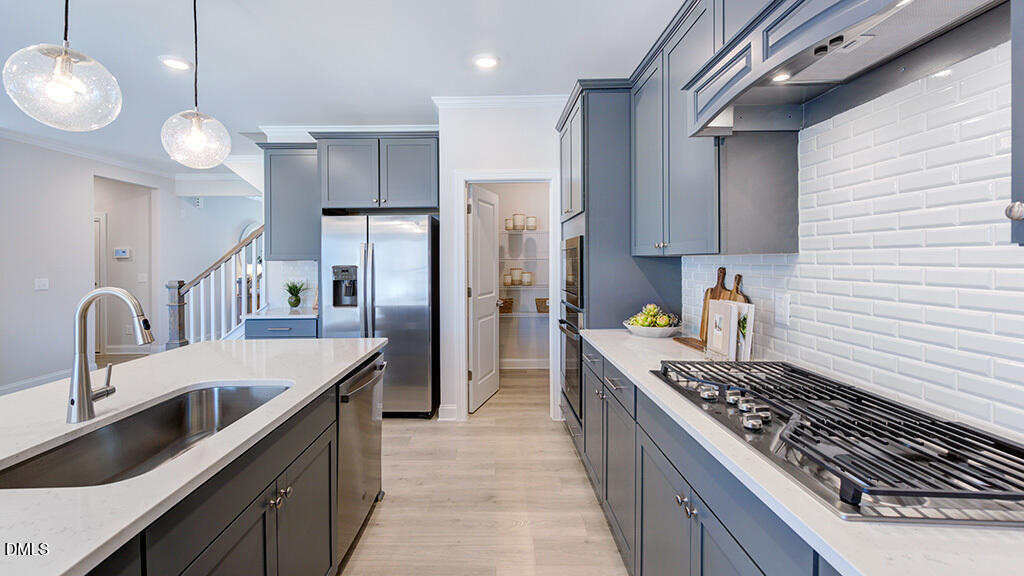 229 Tidal Pool Way Cary, NC 27519 - Photo 9 of 32 a kitchen with stainless steel appliances granite countertop a sink stove and refrigerator
